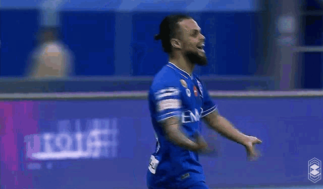 a soccer player wearing a blue shirt that says eaw on it