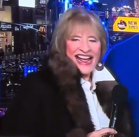 a woman in a fur coat is smiling in front of a mcdonalds sign