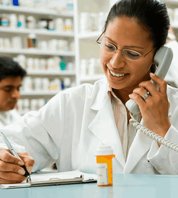 a woman in a lab coat is talking on a phone while writing on a clipboard