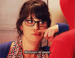 a woman wearing glasses holds her finger to her nose and says bonjour le peen ..