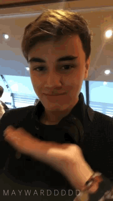 a young man 's face is shown with the words maywardddd on the bottom