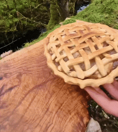 a pie with a lattice crust is on a wooden table