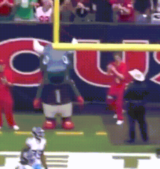 a mascot on a football field with the number 1 on his shirt