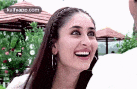 a close up of a woman 's face with a huge smile on her face .