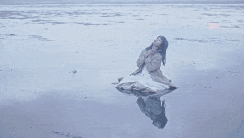 a person 's hand is reaching into the water