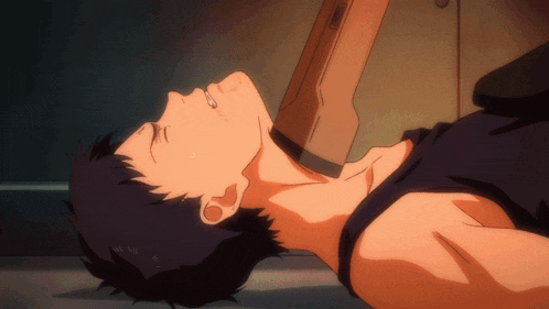 a man in a black tank top is laying on the floor with his eyes closed