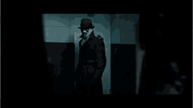 a man in a hat and mask is standing in a doorway with the words `` i must visit the men 's bathroom '' .