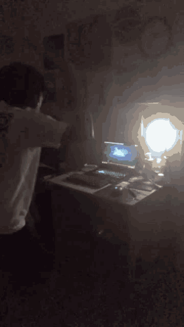 a person sitting at a desk with a laptop