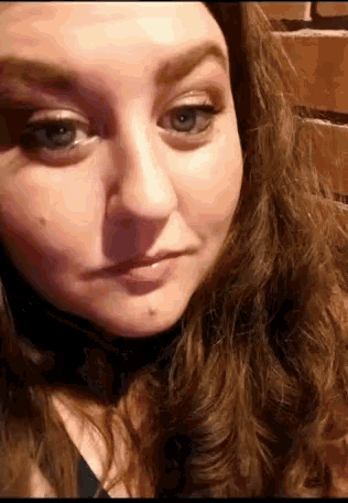 a close up of a woman 's face with her eyes closed