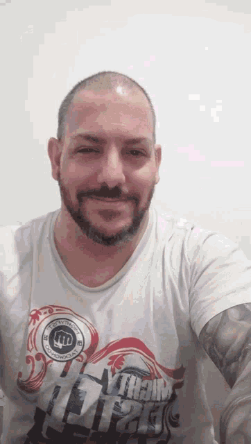 a man with a beard wears a white shirt that says mighty light
