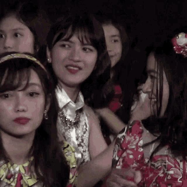 a group of young women are standing next to each other