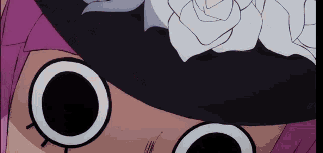 a close up of a person wearing a black hat with a white rose on it