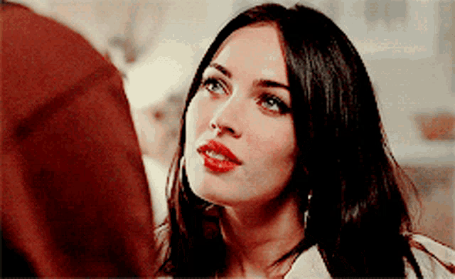 a close up of a woman 's face with a red lip
