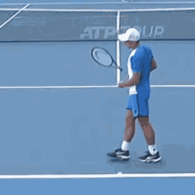 a man holding a tennis racquet on a tennis court
