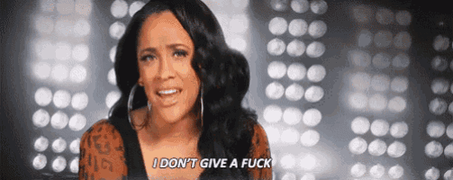 a woman is standing in front of a wall of lights and saying `` i don 't give a fuck '' .