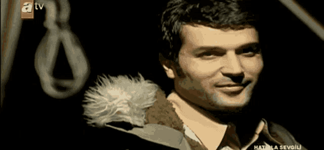 a man 's face is shown on an atv channel