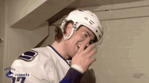 a hockey player with the number 17 on his jersey is laughing