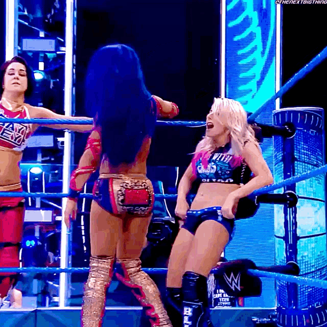 a woman in a wrestling ring is wearing a shirt that says ' i 'm the next thing '