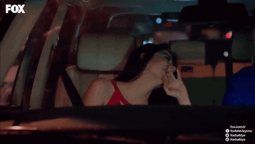 a man and a woman are sitting in a car with fox written on the bottom of the screen