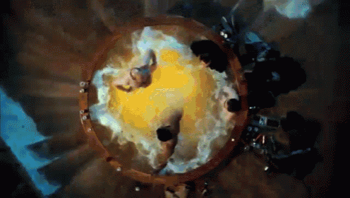 a group of people are sitting in a circle with a yellow object in the middle