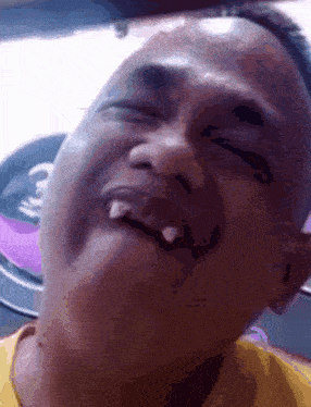 a close up of a man 's face with his eyes closed and his mouth open