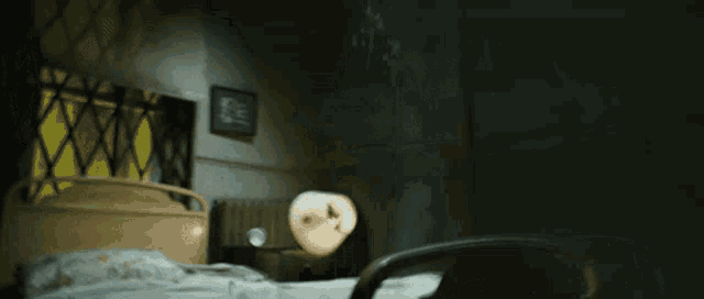 a room with a bed and a lamp with a picture on the wall that says ' i love you '