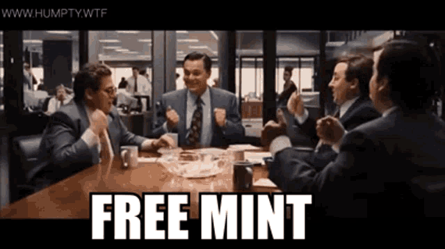 a group of men are sitting around a table with the words free mint written on the table