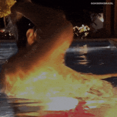 a man is swimming in a pool with the hashtag gokberkbrazil