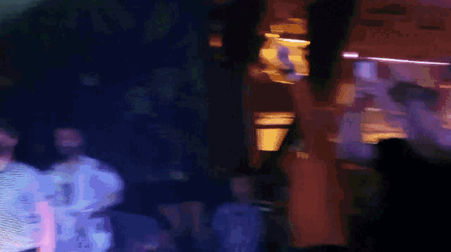 a blurry photo of a crowd of people in a dark room