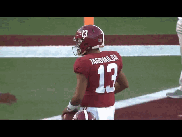 a football player wearing a red jersey with the number 13 on it