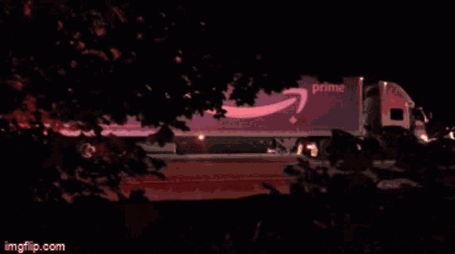 a purple amazon prime truck is parked in the dark