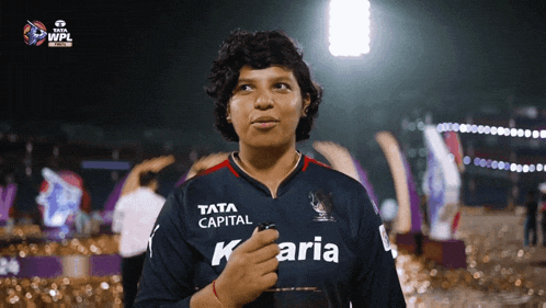 a woman is wearing a shirt that says tata capital k aria