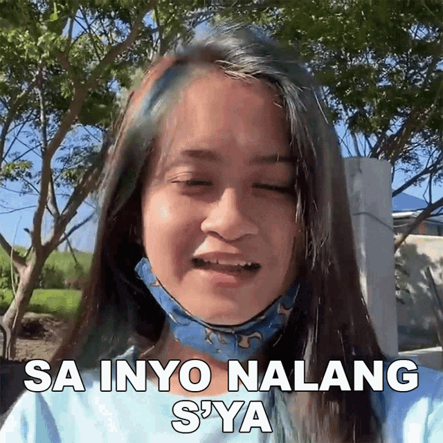 a girl wearing a mask is making a funny face and says sa inyo nalang sya