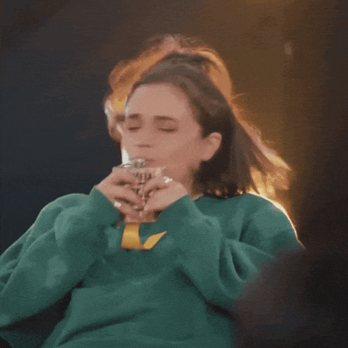 a woman in a green sweater says " do it do it "