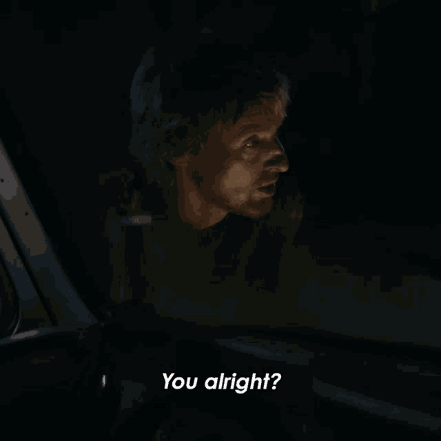 a man in a car says " you alright " while looking out the window