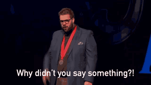 a man wearing glasses and a medal around his neck says why did n't you say something .
