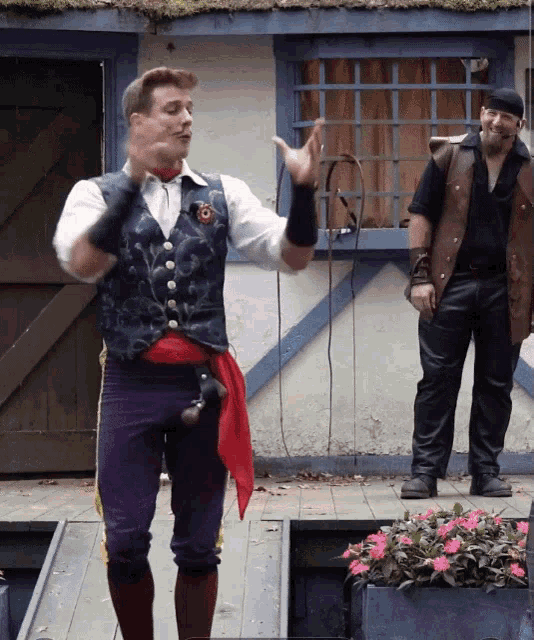 a man in a pirate outfit stands on a stage