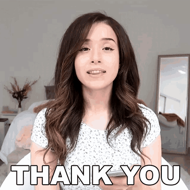 a woman says thank you while holding her phone