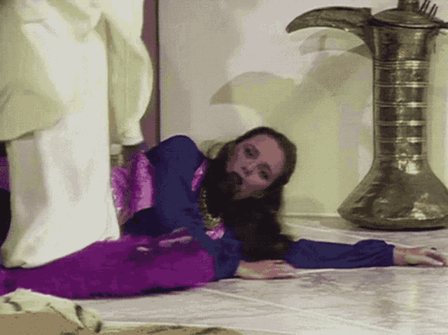 a woman is laying on the floor with her head on the floor