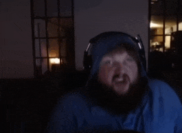 a man with a beard is wearing headphones and a blue hoodie