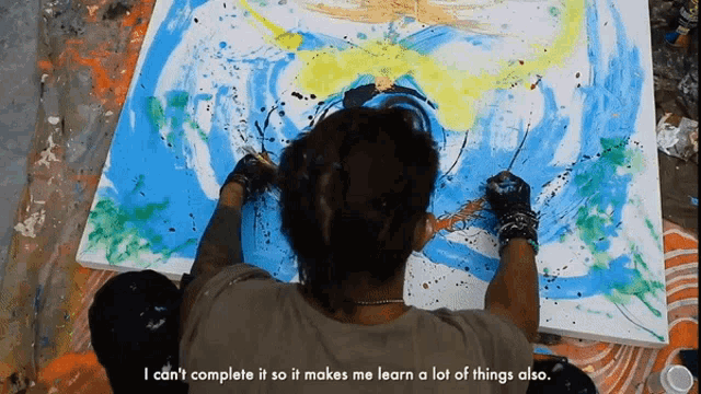 a man is painting on a large canvas with a caption that says i can 't complete it