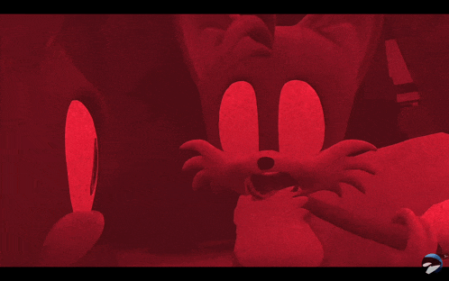 a red background with a cartoon character and the word sonic on the bottom