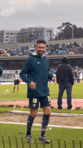 a man in a soccer uniform is running on a field