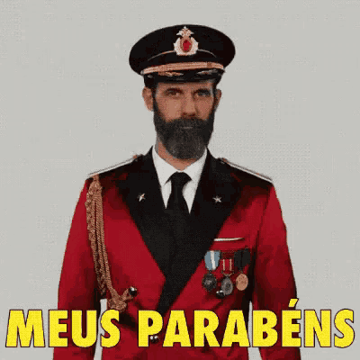 a man with a beard is wearing a red uniform and a black hat and says meus parabens