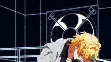 a man with yellow hair stands in front of a fan in a dark room