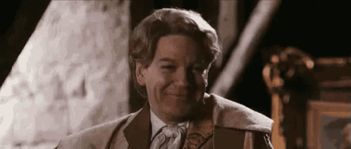 a close up of a man in a suit and tie smiling .