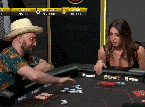 a man in a straw hat is playing poker with a woman in front of him