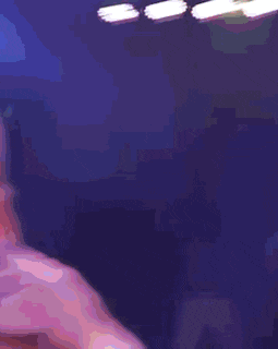 a purple light is shining on a dark background