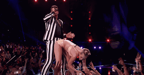 a man is standing next to a woman on a stage .