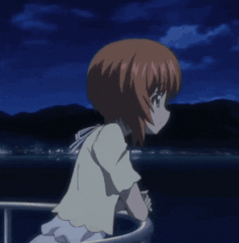a girl in a white dress is looking out over a body of water at night